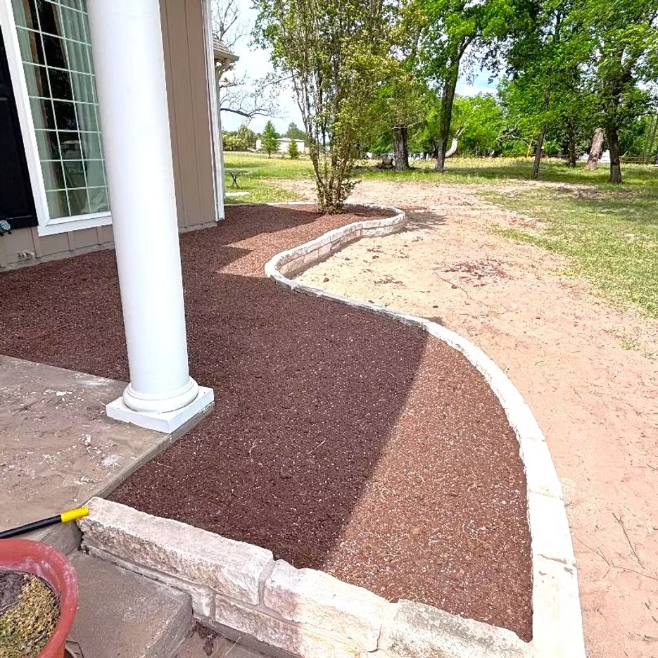 Red mulch installed along a home landscape bed